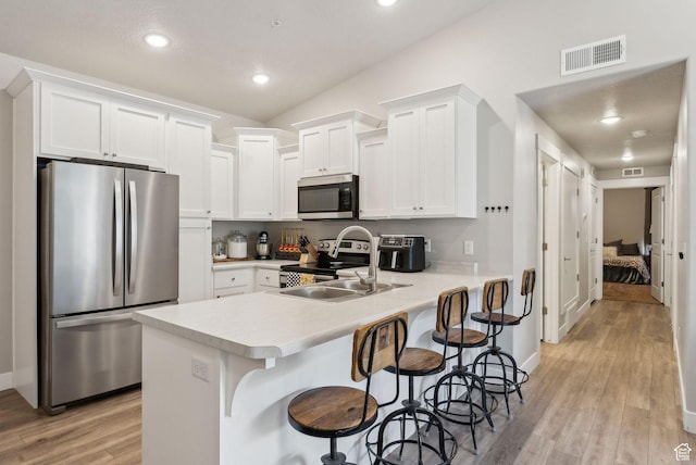 1128 S 820 E Unit 3301, Heber City, UT 84032 - kitchen featuring appliances with stainless steel finishes, a sink, light countertops, light wood-type flooring, and white cabinetry