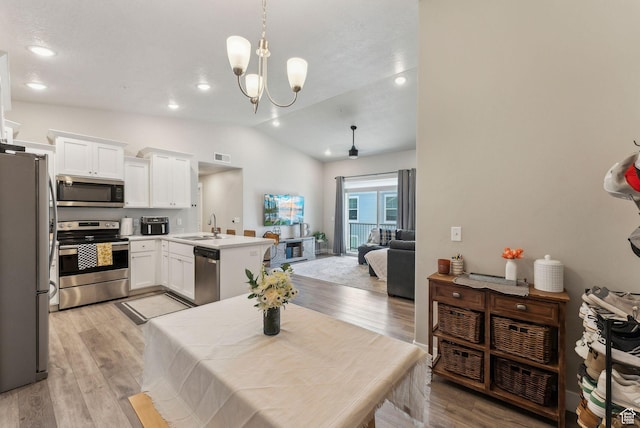 1128 S 820 E Unit 3301, Heber City, UT 84032 - kitchen with stainless steel appliances, a peninsula, open floor plan, white cabinetry, and lofted ceiling