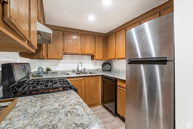 531 S 900 E Unit B2, Salt Lake City, UT 84102 - kitchen featuring stainless steel appliances, under cabinet range hood, a sink, brown cabinetry, and recessed lighting