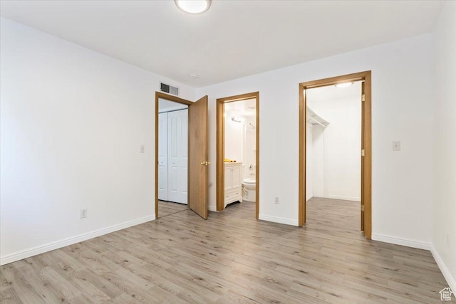 531 S 900 E Unit B2, Salt Lake City, UT 84102 - unfurnished bedroom with light wood-type flooring, baseboards, ensuite bathroom, a walk in closet, and a closet
