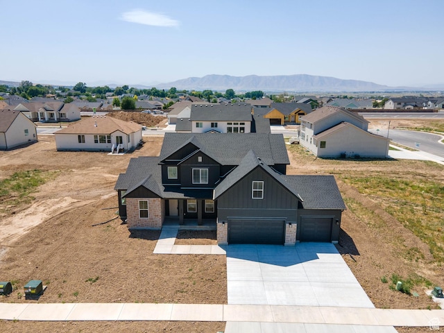 325 N 1040 E Unit 26, Salem, UT 84653 - view of front facade featuring board and batten siding, a residential view, concrete driveway, and brick siding