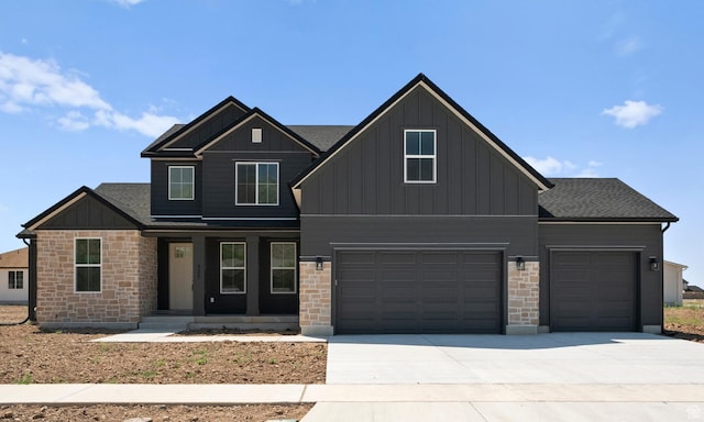 325 N 1040 E Unit 26, Salem, UT 84653 - view of front of property featuring stone siding, covered porch, board and batten siding, driveway, and an attached garage