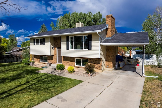 366 S 3240 W, Vernal, UT 84078 - bi-level home with concrete driveway, an attached carport, brick siding, and a chimney