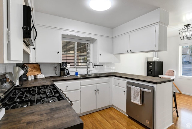345 W 300 N, Richfield, UT 84701 - kitchen with dishwasher, a sink, gas stove, tasteful backsplash, and light wood-type flooring
