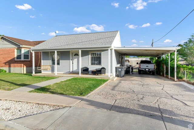 345 W 300 N, Richfield, UT 84701 - view of front of home featuring an attached carport, a front yard, a porch, driveway, and roof with shingles