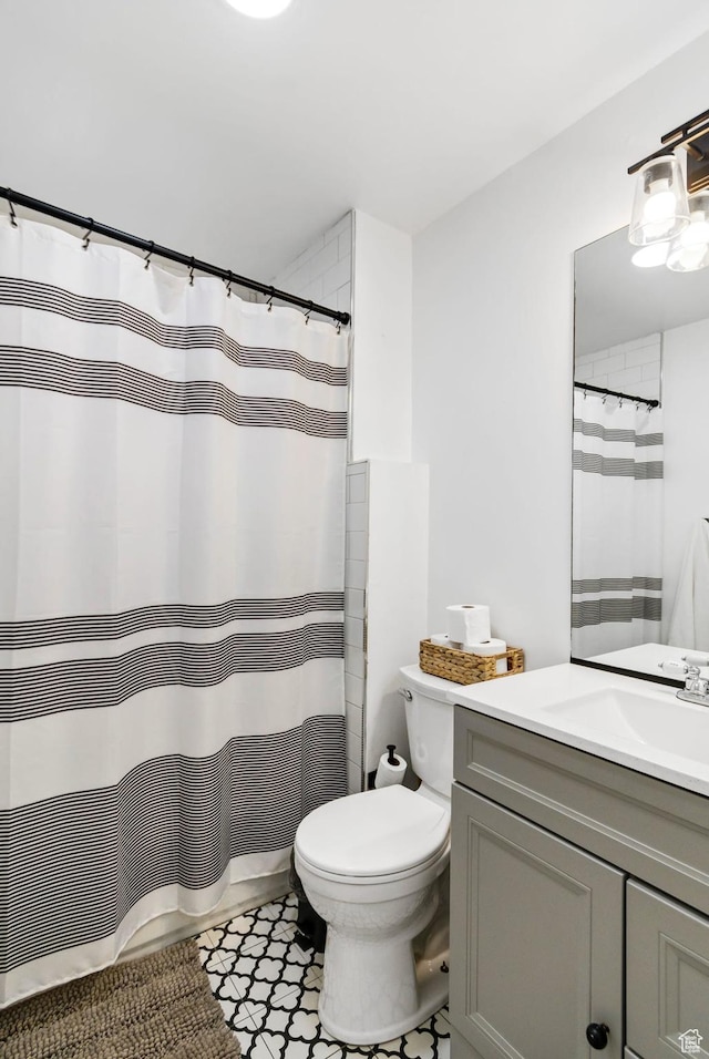 345 W 300 N, Richfield, UT 84701 - bathroom with vanity, toilet, tile patterned flooring, and curtained shower