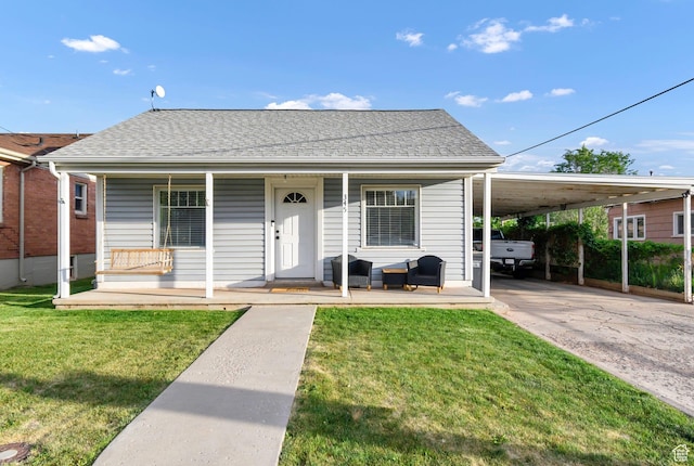 345 W 300 N, Richfield, UT 84701 - view of front facade with a porch, a front lawn, a carport, and roof with shingles