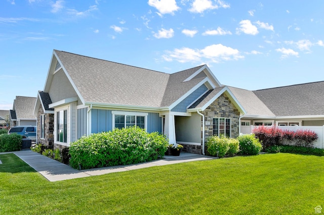 742 W 130 S Unit D, Pleasant Grove, UT 84062 - craftsman house with stone siding, a front yard, a shingled roof, and board and batten siding