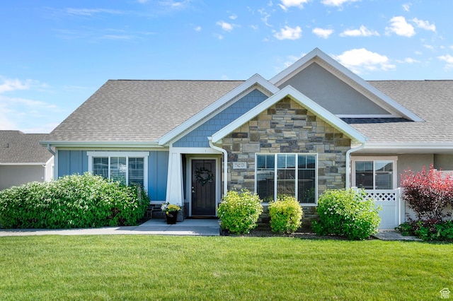 742 W 130 S Unit D, Pleasant Grove, UT 84062 - view of front of house with stone siding, a front yard, a shingled roof, and board and batten siding