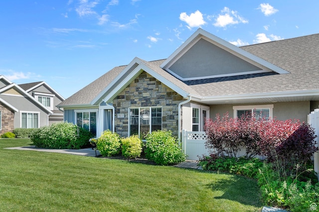 742 W 130 S Unit D, Pleasant Grove, UT 84062 - view of front of home with stone siding, a front lawn, and a shingled roof