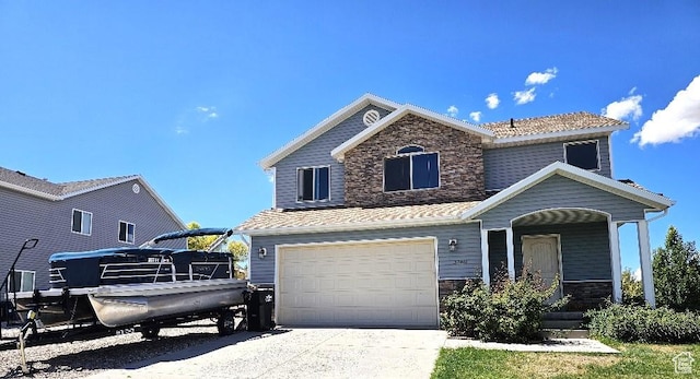 3788 S 410 W, Vernal, UT 84078 - traditional-style house with stone siding, a garage, covered porch, and driveway