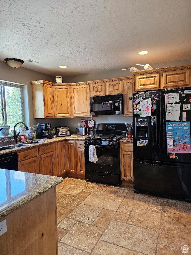 3788 S 410 W, Vernal, UT 84078 - kitchen with black appliances, recessed lighting, a textured ceiling, light stone countertops, and a sink