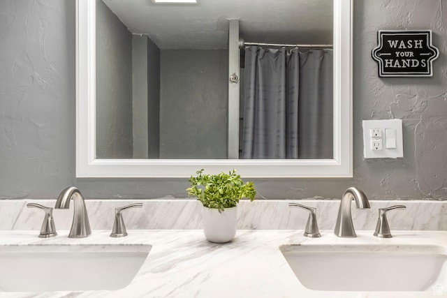 10297 S Weeping Willow Dr E, Sandy, UT 84070 - bathroom featuring double vanity and a textured wall