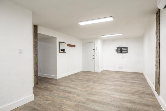 10297 S Weeping Willow Dr E, Sandy, UT 84070 - empty room with a wall mounted AC, light wood-type flooring, and baseboards