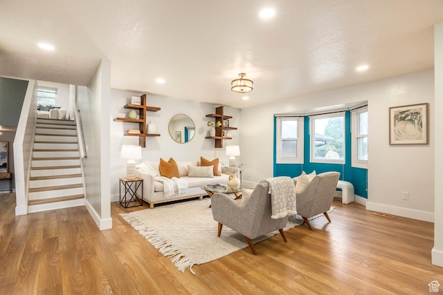 10297 S Weeping Willow Dr E, Sandy, UT 84070 - living room with stairs, wood finished floors, baseboards, plenty of natural light, and recessed lighting