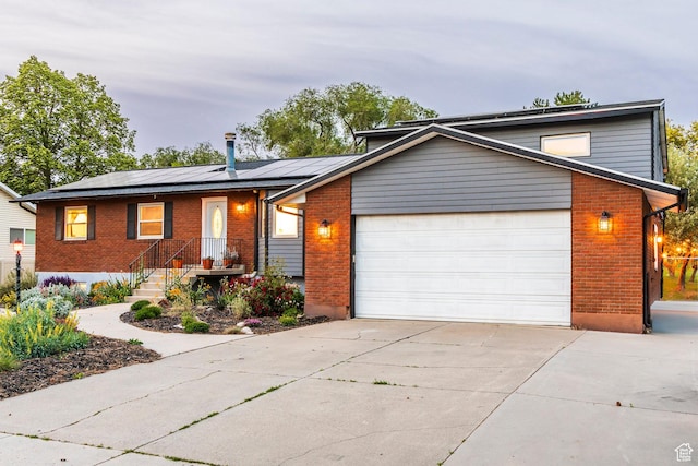 10297 S Weeping Willow Dr E, Sandy, UT 84070 - view of front of home with brick siding, driveway, and a garage