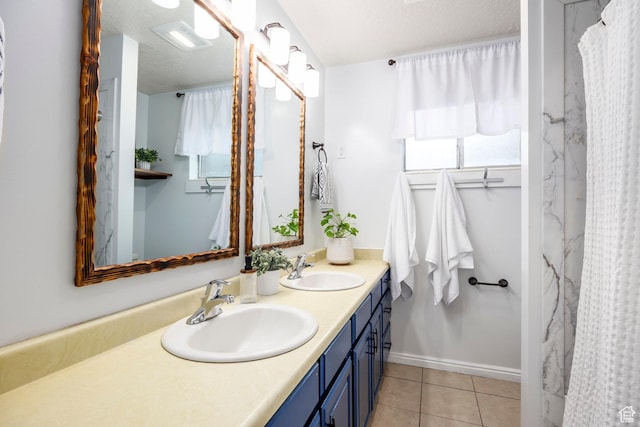 10297 S Weeping Willow Dr E, Sandy, UT 84070 - full bathroom featuring double vanity, tile patterned flooring, curtained shower, and baseboards