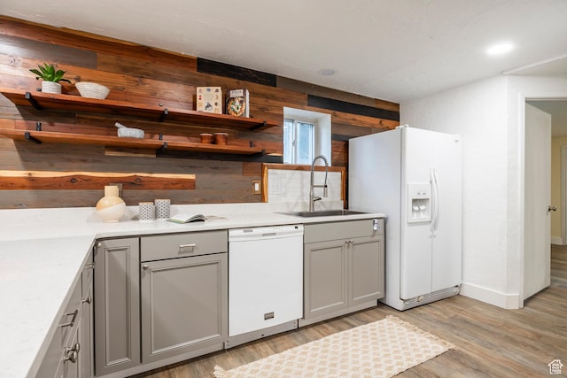 10297 S Weeping Willow Dr E, Sandy, UT 84070 - kitchen featuring white appliances, gray cabinets, wooden walls, and a sink