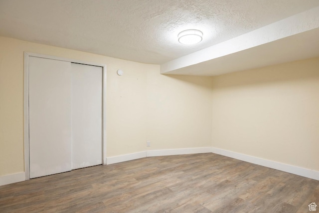 10297 S Weeping Willow Dr E, Sandy, UT 84070 - finished basement featuring wood finished floors, a textured ceiling, and baseboards