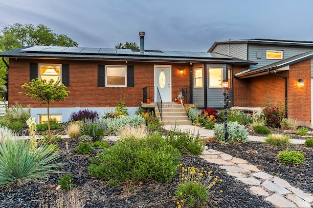 10297 S Weeping Willow Dr E, Sandy, UT 84070 - view of front of home with brick siding and roof mounted solar panels