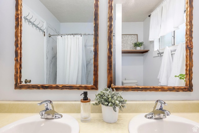 10297 S Weeping Willow Dr E, Sandy, UT 84070 - bathroom featuring toilet, a textured ceiling, and double vanity