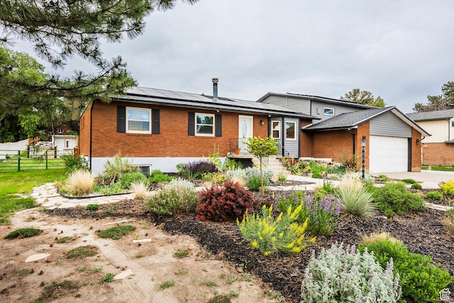 10297 S Weeping Willow Dr E, Sandy, UT 84070 - tri-level home featuring brick siding, solar panels, a garage, and driveway