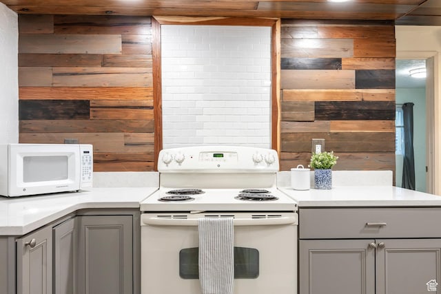 10297 S Weeping Willow Dr E, Sandy, UT 84070 - kitchen featuring white appliances, gray cabinetry, wood walls, and light countertops