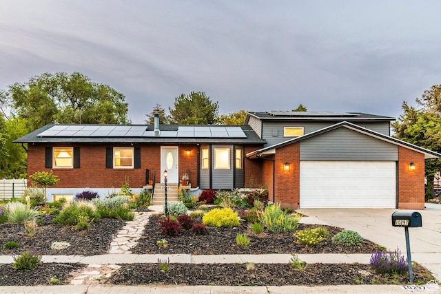 10297 S Weeping Willow Dr E, Sandy, UT 84070 - view of front of home with brick siding and roof mounted solar panels
