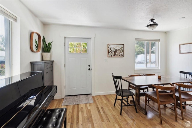 1142 W Fremont Ave, Salt Lake City, UT 84104 - dining space with light wood-style flooring, baseboards, and a textured ceiling