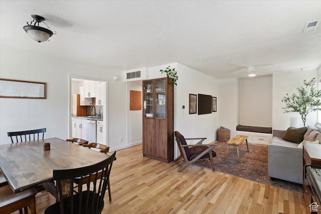 1142 W Fremont Ave, Salt Lake City, UT 84104 - dining room with light wood-style flooring and a textured ceiling