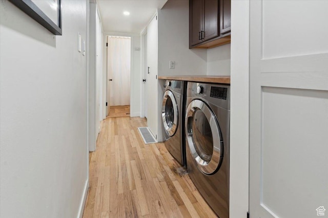 1142 W Fremont Ave, Salt Lake City, UT 84104 - washroom featuring cabinet space, washing machine and dryer, light wood-style floors, baseboards, and recessed lighting