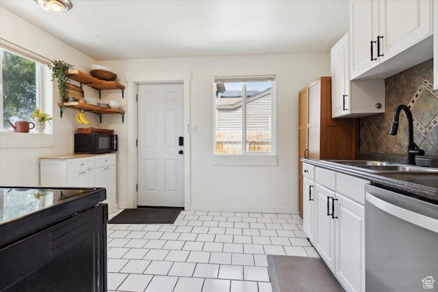 1142 W Fremont Ave, Salt Lake City, UT 84104 - kitchen featuring stainless steel dishwasher, black microwave, a sink, decorative backsplash, and white cabinetry