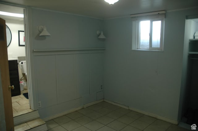 682 W 400 N, Payson, UT 84651 - unfurnished bedroom featuring a decorative wall, a wainscoted wall, ornamental molding, and light tile patterned flooring