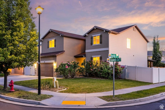 991 N Elizabeth Dr W, North Salt Lake, UT 84054 - traditional home featuring a garage, stucco siding, and concrete driveway