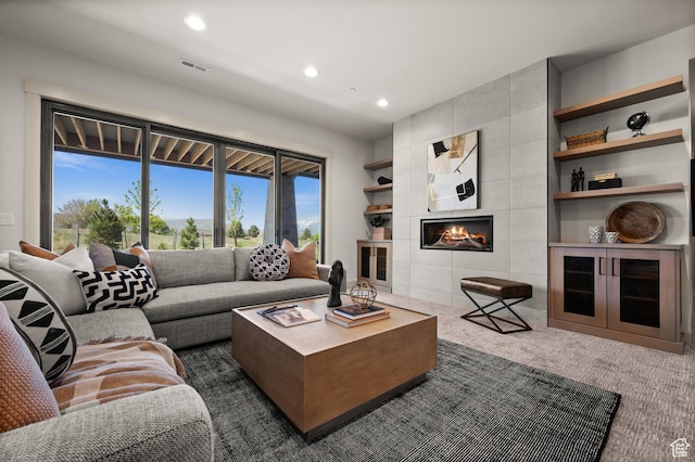 113 N Haystack Mountain Dr Unit 2, Heber City, UT 84032 - living room featuring recessed lighting, dark colored carpet, a tiled fireplace, and built in shelves
