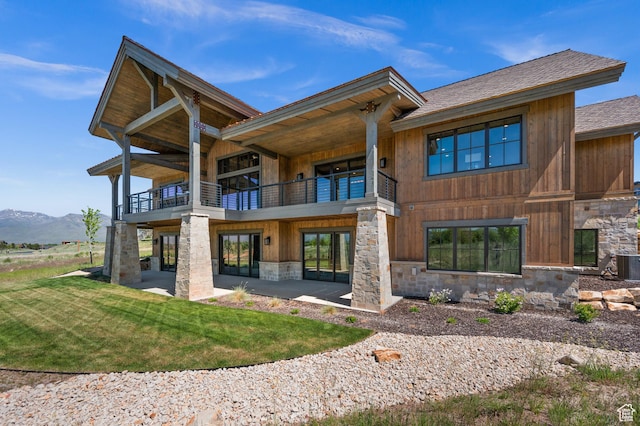 113 N Haystack Mountain Dr Unit 2, Heber City, UT 84032 - rear view of house with a balcony, stone siding, a patio, and a lawn