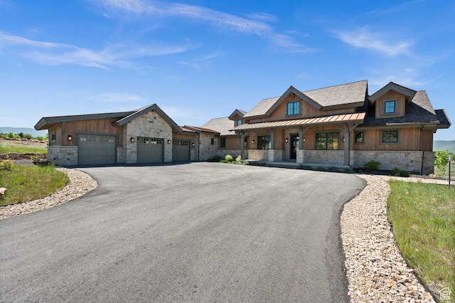 113 N Haystack Mountain Dr Unit 2, Heber City, UT 84032 - view of front of property with stone siding, asphalt driveway, a garage, and covered porch