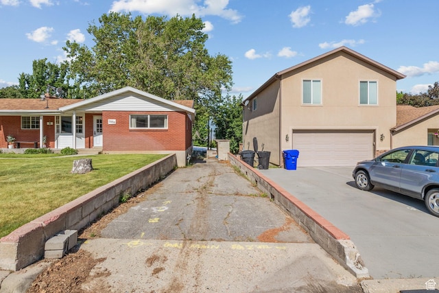 2858 S 50 W, Bountiful, UT 84010 - view of side of property with asphalt driveway, a garage, a lawn, and brick siding