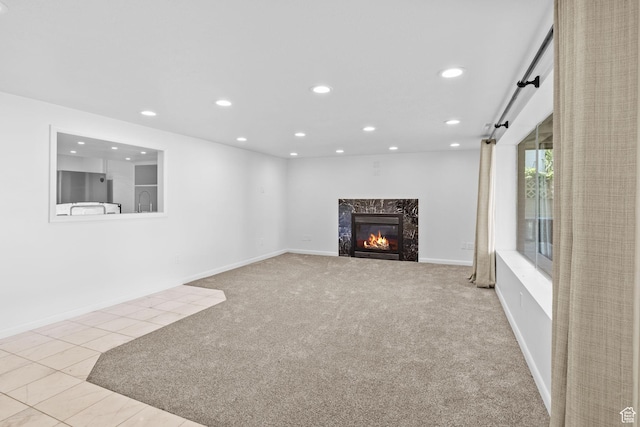 2858 S 50 W, Bountiful, UT 84010 - unfurnished living room with recessed lighting, a premium fireplace, carpet floors, tile patterned flooring, and baseboards