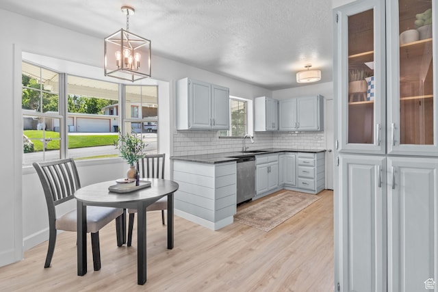 2858 S 50 W, Bountiful, UT 84010 - kitchen with dishwasher, dark countertops, tasteful backsplash, light wood-type flooring, and pendant lighting