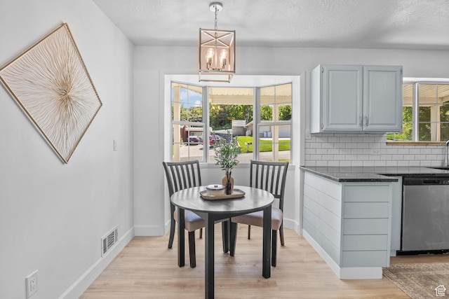 2858 S 50 W, Bountiful, UT 84010 - dining area featuring baseboards, light wood-style floors, a chandelier, and a textured ceiling