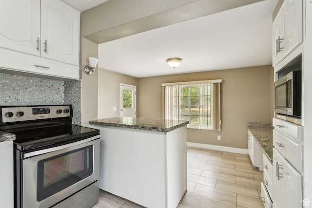 2937 S 900 E, Salt Lake City, UT 84106 - kitchen featuring stainless steel appliances, decorative backsplash, white cabinetry, a peninsula, and baseboards