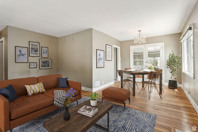 2937 S 900 E, Salt Lake City, UT 84106 - living area featuring light wood-style floors, a chandelier, and baseboards