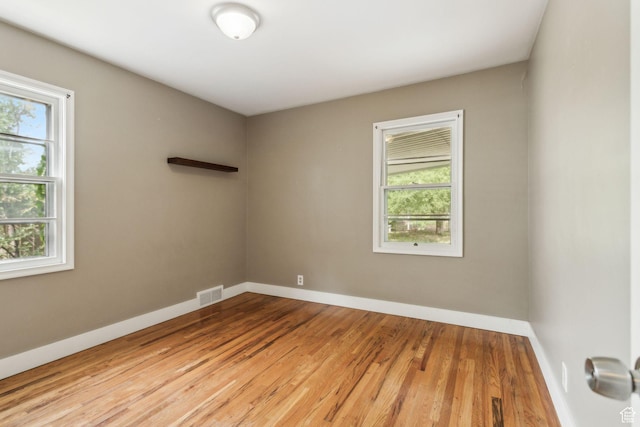 2937 S 900 E, Salt Lake City, UT 84106 - unfurnished room featuring plenty of natural light, wood finished floors, and baseboards