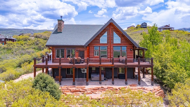 1551 Tree Top Ln Unit 360, Heber City, UT 84032 - rear view of house with a patio area, a deck with mountain view, and a chimney