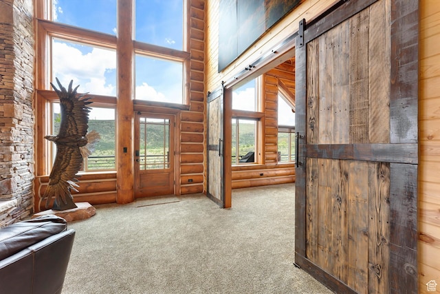 1551 Tree Top Ln Unit 360, Heber City, UT 84032 - doorway with log walls, a towering ceiling, carpet, and a barn door