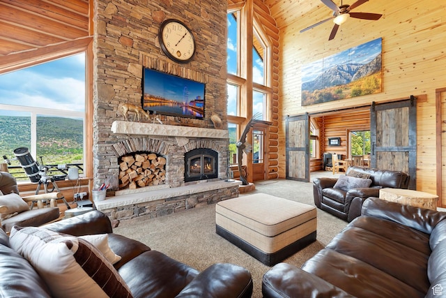 1551 Tree Top Ln Unit 360, Heber City, UT 84032 - living area with a towering ceiling, carpet floors, a stone fireplace, ceiling fan, and plenty of natural light