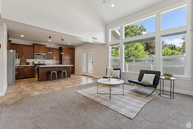 4269 S Haven Park Way, Holladay, UT 84124 - living room with light carpet, baseboards, high vaulted ceiling, recessed lighting, and light tile patterned floors