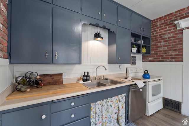 2955 S Jefferson Ave E, Ogden, UT 84403 - kitchen featuring a sink, white range with electric stovetop, blue cabinets, brick wall, and light countertops