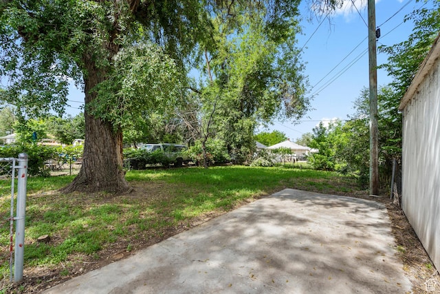 2955 S Jefferson Ave E, Ogden, UT 84403 - view of grassy yard featuring a patio area